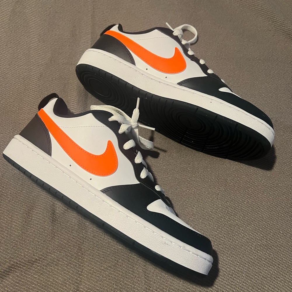 Like new black and white Nike dunks with neon orange check. Worn once.